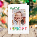 Colourful Merry and Bright Christmas Photo Greetin Holiday Card<br><div class="desc">This fun, bright Christmas holiday greeting card features colourful text, reading, "Merry & Bright" in green, lime, cherry red, pink, golden yellow, and aqua. The typography for the word "Bright" incorporates an overlapping tissue paper design. This lighthearted card evokes a sense of playfulness, laughter, and childhood joy in the simple...</div>