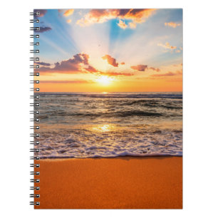 Colourful ocean beach sunrise with deep blue sky a notebook