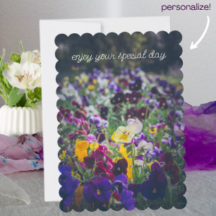 Colourful pansies in bloom in the country garden holiday card