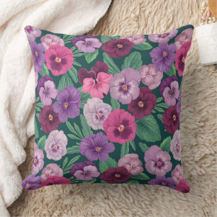 Colourful pansies on dark greenish blue cushion