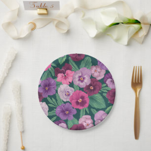 Colourful pansies on dark greenish blue paper plate