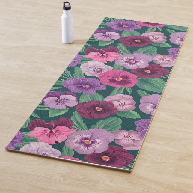 Colourful pansies on dark greenish blue yoga mat (In Situ)