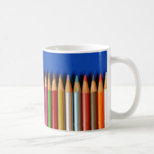 Colourful pencil crayons on blue background coffee mug