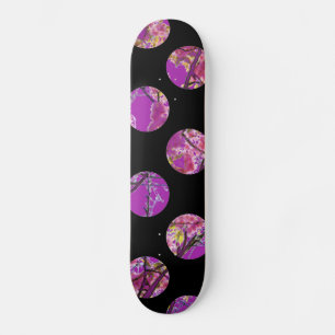 Colourful purple circles on black skateboard