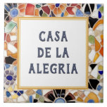 Colourful Spanish Mosaic Custom House Name Plate Tile<br><div class="desc">Please note: This is a faux mosaic. It is a printed graphic giving the illusion of mosaic stones. "custom house name plate", "personalised house name plaque", "personal customised text sign", "modern abstract design ceramic tile", "multicolored colourful gaudi mosaic", "building group home name art", "bright vibrant yellow blue", "last family name...</div>