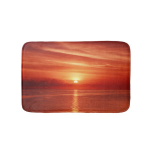 Colourful sunrise at sea, dramatic clouds. bath mat