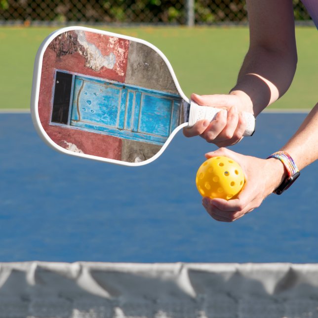 Colourful wall with blue door pickleball paddle (Insitu)