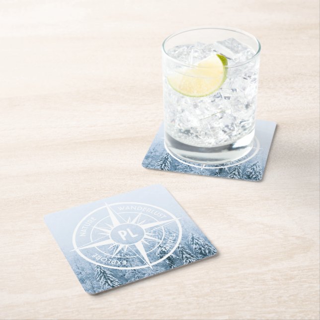 Compass star emblem monogram winter spruce forest square paper coaster (Insitu)