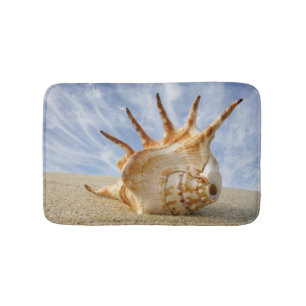 Conch Shell on Sandy Beach, Blue Sky Bath Mat