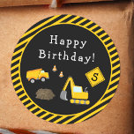 Construction Happy Birthday with Age Boy Classic Round Sticker<br><div class="desc">Celebrate your little one's special day with this custom boy birthday party sticker with an adorable construction theme. Each sticker has a dump truck and excavator working together at a road construction site. There are also orange traffic cones and yellow and black stripes. Add your child's age for a special...</div>