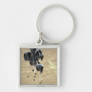 Container delivery system bundles parachute key ring
