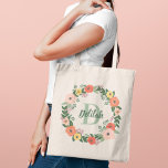 Coral Pink Floral Greenery Monogram Wreath Tote Bag<br><div class="desc">Whimsical floral custom tote bag design features beautiful watercolor flowers and greenery in a round wreath that frames your custom monogram name and initial. Colours include blush pink, coral orange, yellow, and violet flowers with lush sage and darker green foliage and leaves. Makes a lovely gift for your bridesmaids and...</div>