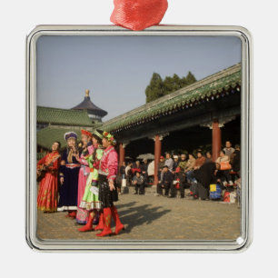 Costumed amateur folk dancers entertain metal tree decoration