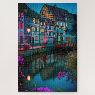 Cottages at night on river in France Jigsaw Puzzle