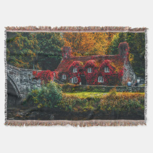 Country Cottage with Red Vines Covering Home Throw Blanket