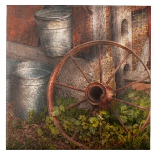 Country - Some dented pails and an old wheel Tile