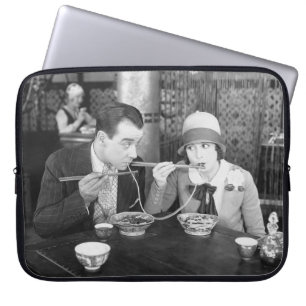 Couple sharing a noodle in a restaurantvintage, fo laptop sleeve