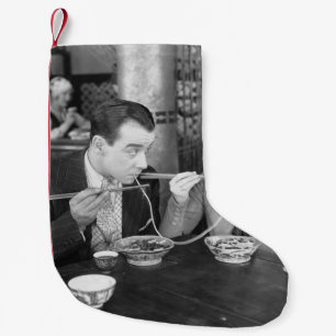 Couple sharing a noodle in a restaurantvintage, fo small christmas stocking