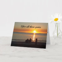 Couple Sit On Beach At Sunset Anniversary Card