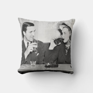 Couple sitting together in a restaurant flirting w cushion