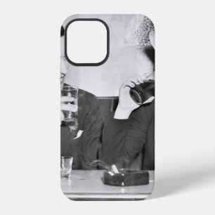 Couple sitting together in a restaurant flirting w iPhone 12 case