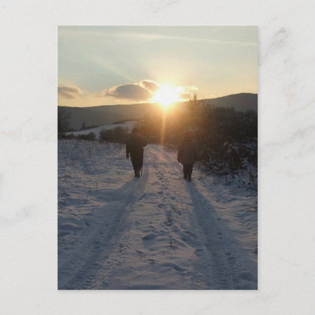 Couple walking in the snow at sunset postcard (Front)