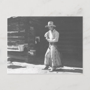 Cowboy eating from a Peter Pan peanutbutter can. Postcard