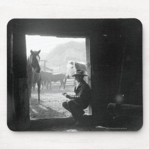 Cowboy in a doorway with horses mouse mat