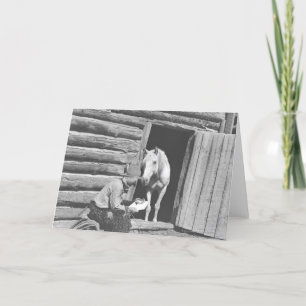 Cowboy reading a letter with a horse card