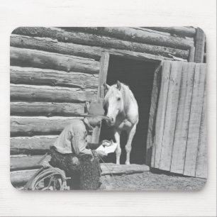 Cowboy reading a letter with a horse mouse mat