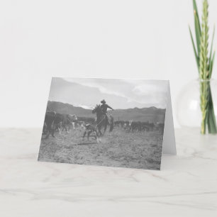 Cowboy roping a calf for spring branding. card