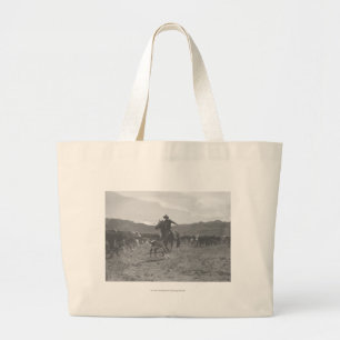 Cowboy roping a calf for spring branding. large tote bag