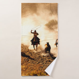 Cowboys chasing wilding horses. roping and riding, bath towel