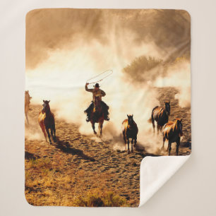 Cowboys chasing wilding horses. roping and riding, sherpa blanket