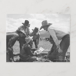 Cowboys looking a magazine postcard