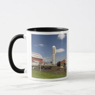 Cows in front of a red barn and silo on a farm mug