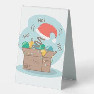 Craft box with Christmas decoration and Santa hat 