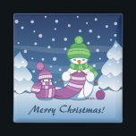 Crafty Snowman Knitting Scarf Magnet<br><div class="desc">Vector illustration of two adorable cartoon snowmen dressed in knitted hats and scarves. The big crafty snowman is knitting an oversized scarf for the little one. The scarf is already wrapped several times around the cute little snowman.</div>