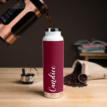 Cranberry Red Personalised Wedding Bridesmaid Water Bottle<br><div class="desc">Gift your wedding bridesmaid or maid of honour with this trendy, vacuum Insulated water bottle that features her name in white, stylised script on a cranberry red colour background designed to match your wedding colour scheme. Personalise bottle by editing and replacing name with your own as desired. Select your water...</div>