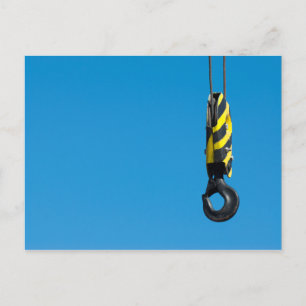 Crane hook with yellow and black stripes hanging postcard
