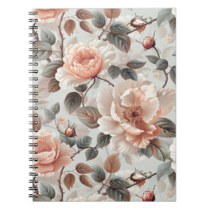 Cream flowers with grey leaves on a light grey notebook