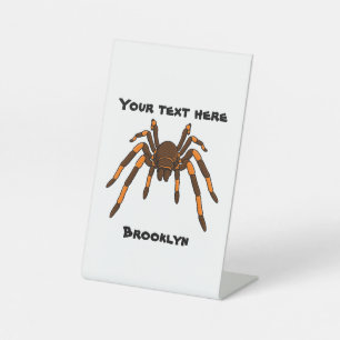Creepy brown and orange tarantula spider cartoon pedestal sign