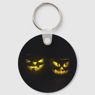 Creepy yellow glow spooky pumpkin faces on black key ring