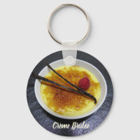 Creme brulee on slate with raspberry and vanilla