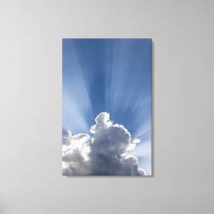 Crepuscular or God's rays streak past cloud. Canvas Print