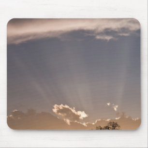 Crepuscular rays radiate across the sky at mouse mat