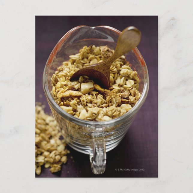 Crunchy muesli with wooden spoon in a measuring postcard (Front)