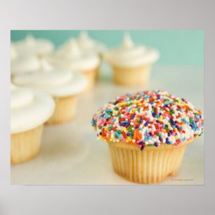 Cupcakes, focus on one in front with poster