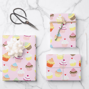 Cupcakes on pink wrapping paper sheet