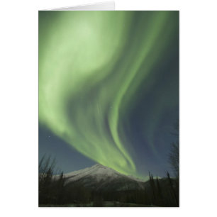 Curtains of green aurora borealis in the sky